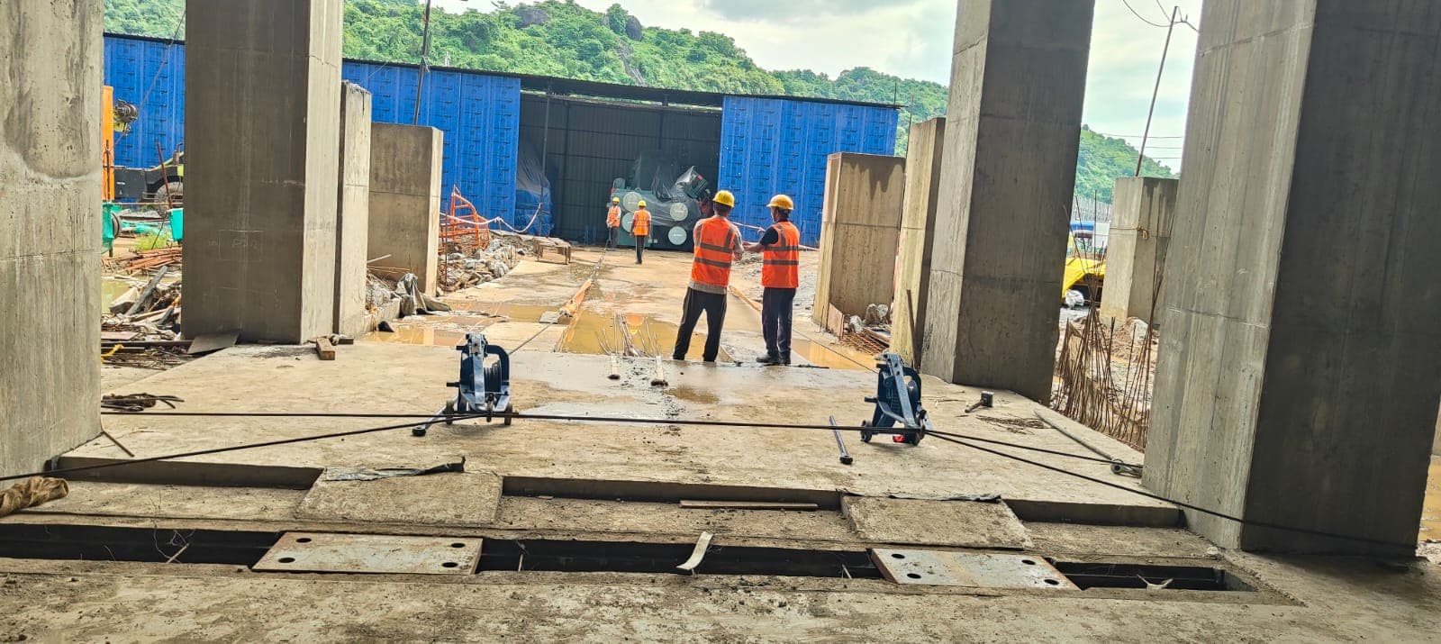 Winches and wire rope under tension on steel plate track during a chiller move at the OSAT semiconductor facility, Assam